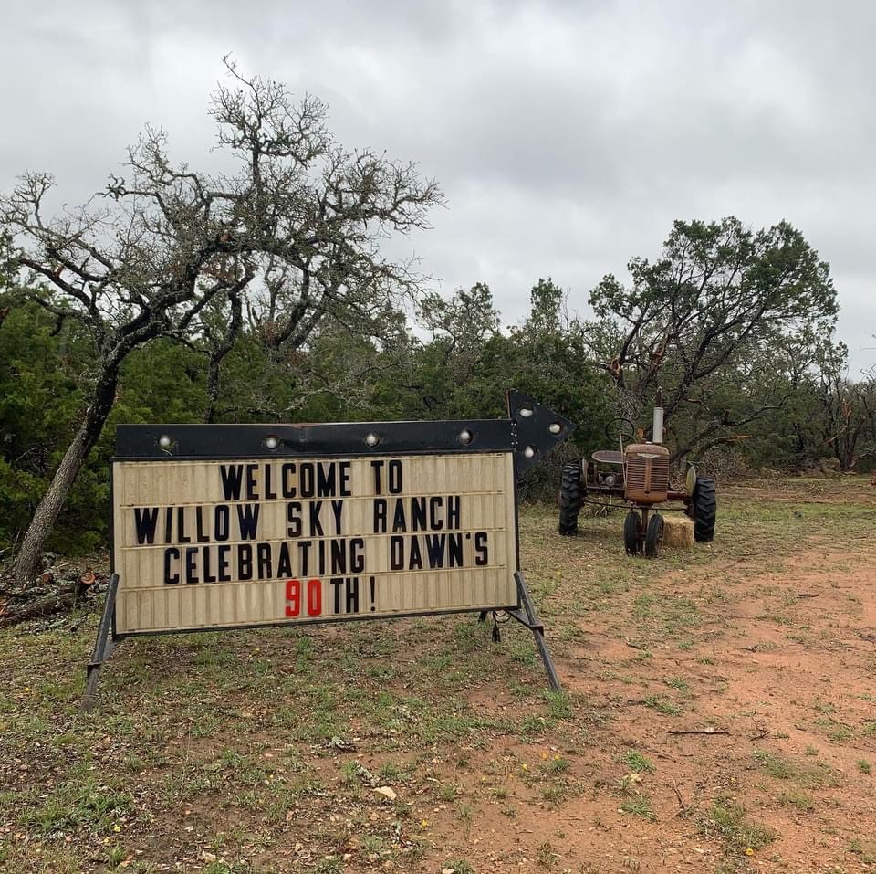 Welcome to Willow Sky Ranch celebration sign with vintage tractor